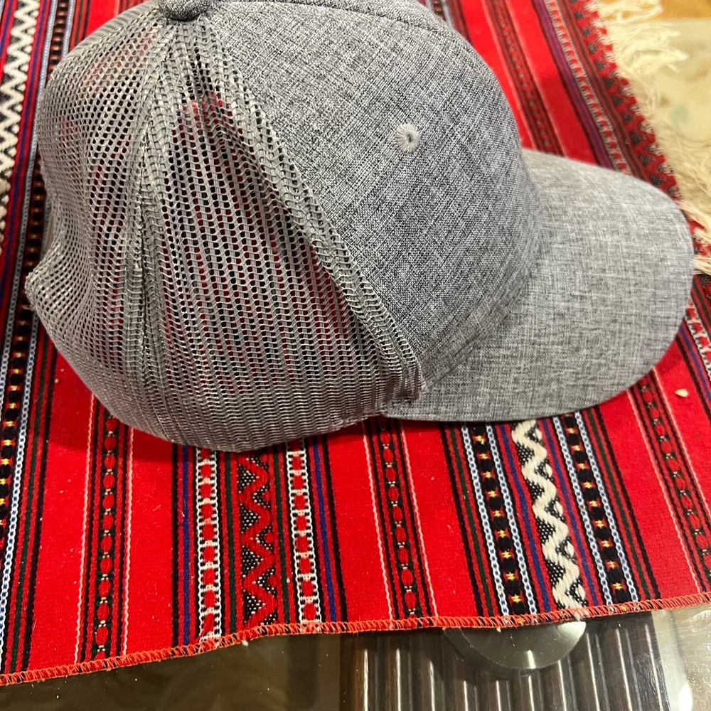 Grey baseball hat one size fits all. Plastic size adjustable in the back